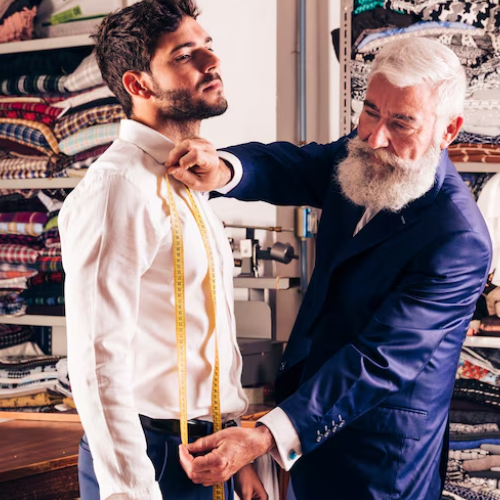 Man getting fitted by tailor
